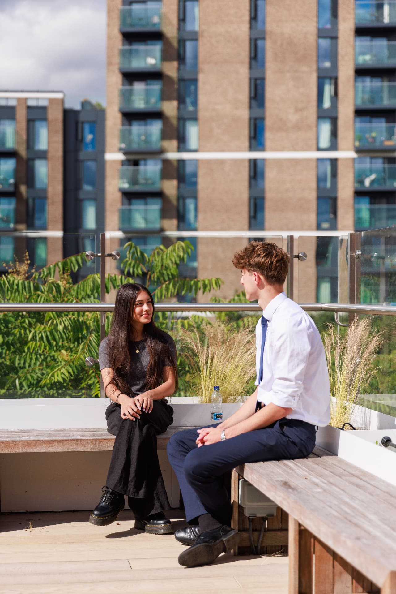 Two Sixth Form students talking on the school roof terrace