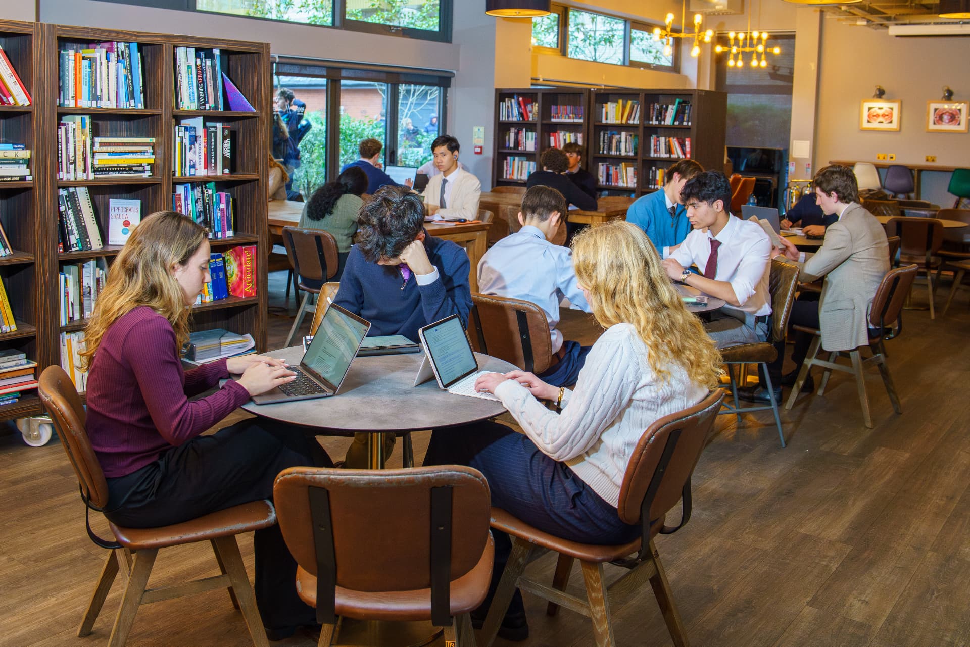 Sixth Form students studying together in the school library